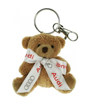 Small soft bear on a keyring, personalised with a branded ribbon tied around its neck