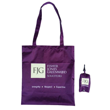 Purple long handled foldable shopping bag with storage pouch, both branded with a company logo. 