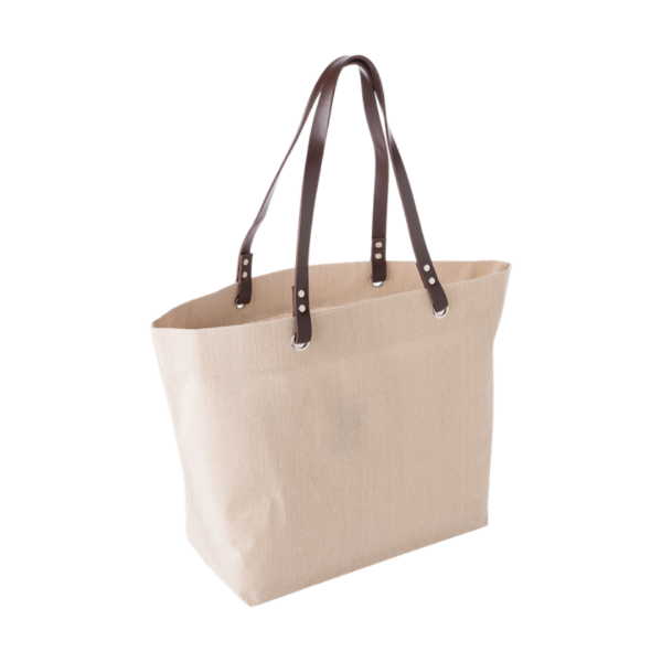 A cream colour linen beach bag with dark brown handles