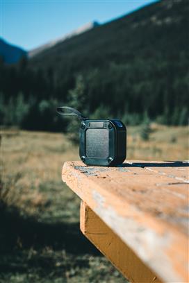 3W RCS recycled plastic wireless sunwave solar speaker being charged in the sunlight